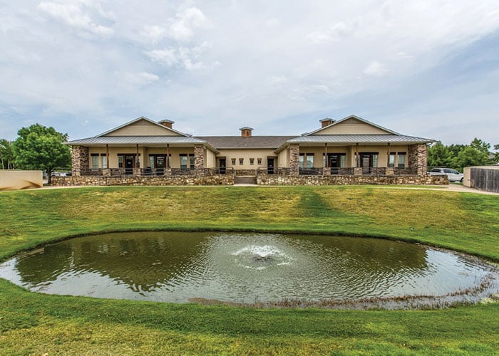 A large building with water in front of it.