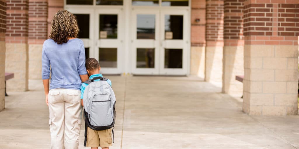 A woman and child walking down the sidewalk.