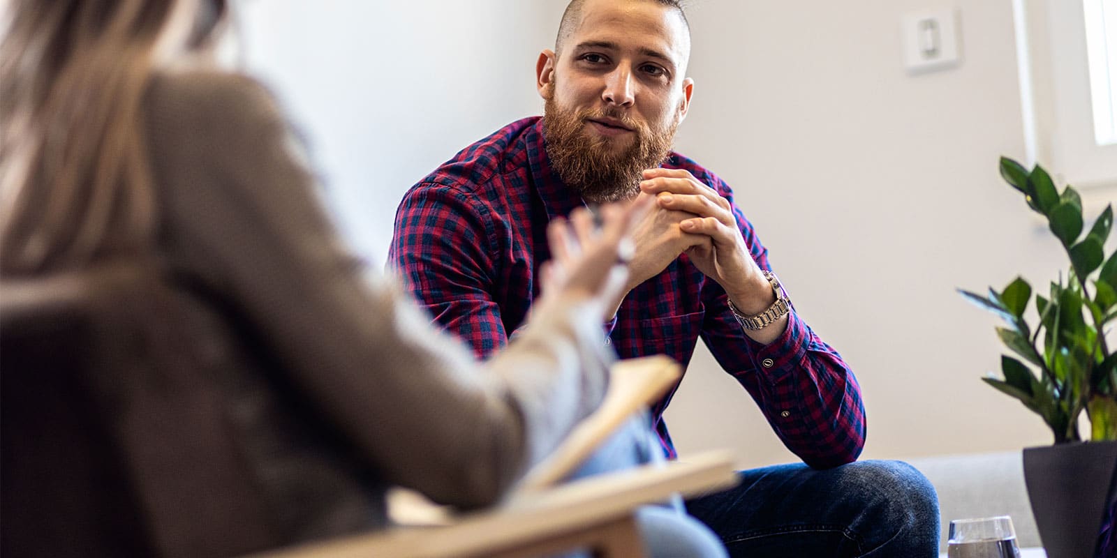 A man sitting in front of another person.